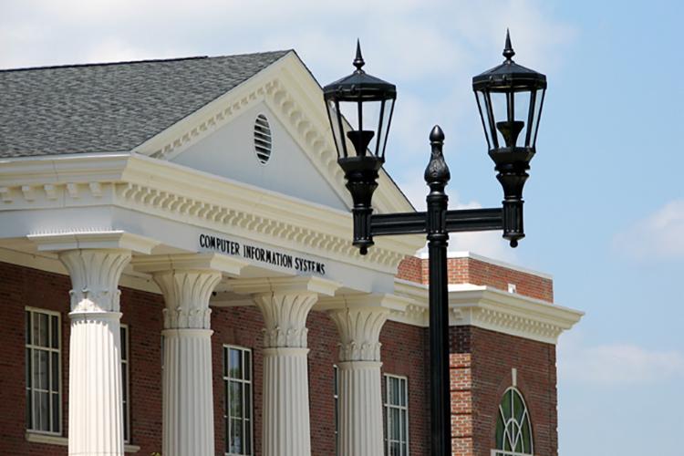 Windsor Decorative Post Top in front of UNCW campus building